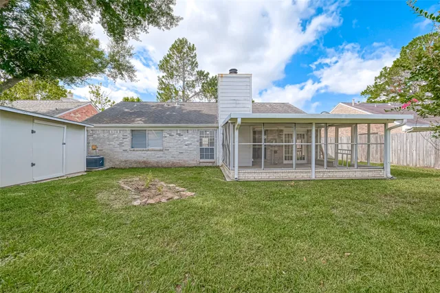 a view of a house with a backyard