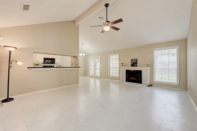 a view of a kitchen with an empty space and a fireplace