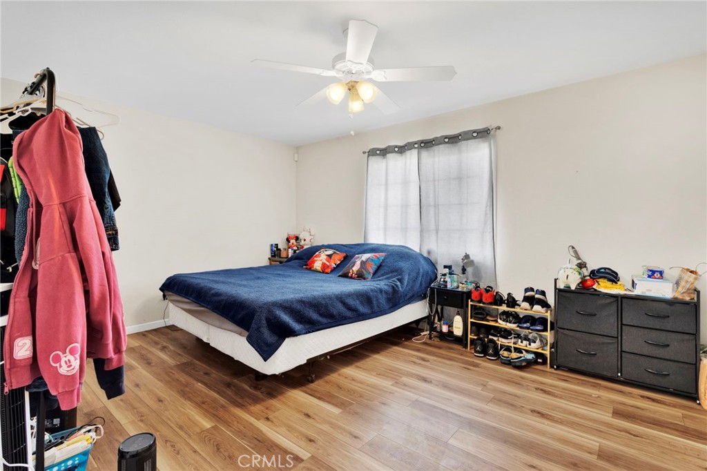 18350 Jonathan Street Adelanto, CA 92301 - Photo 15 of 32 a bed room with a bed and a chair