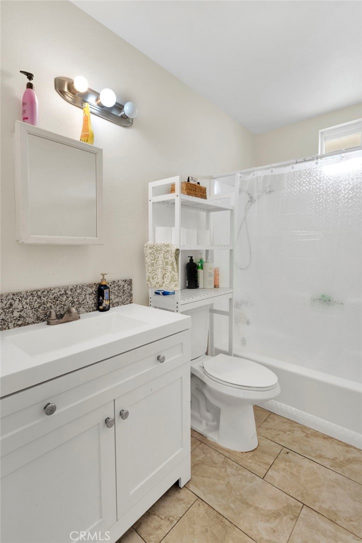 18350 Jonathan Street Adelanto, CA 92301 - Photo 19 of 32 a bathroom with a sink a toilet and shower