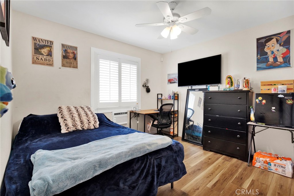 18350 Jonathan Street Adelanto, CA 92301 - Photo 20 of 32 a bedroom with a bed and a flat screen tv
