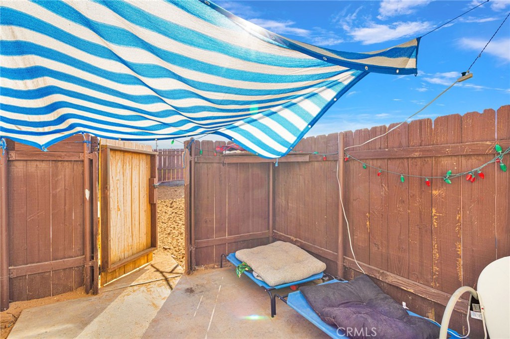 18350 Jonathan Street Adelanto, CA 92301 - Photo 24 of 32 a room with a chair and large windows