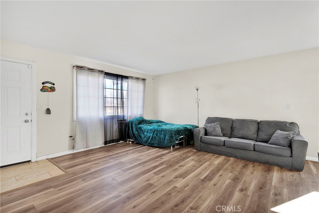 18350 Jonathan Street Adelanto, CA 92301 - Photo 8 of 32 a bedroom with furniture and a window