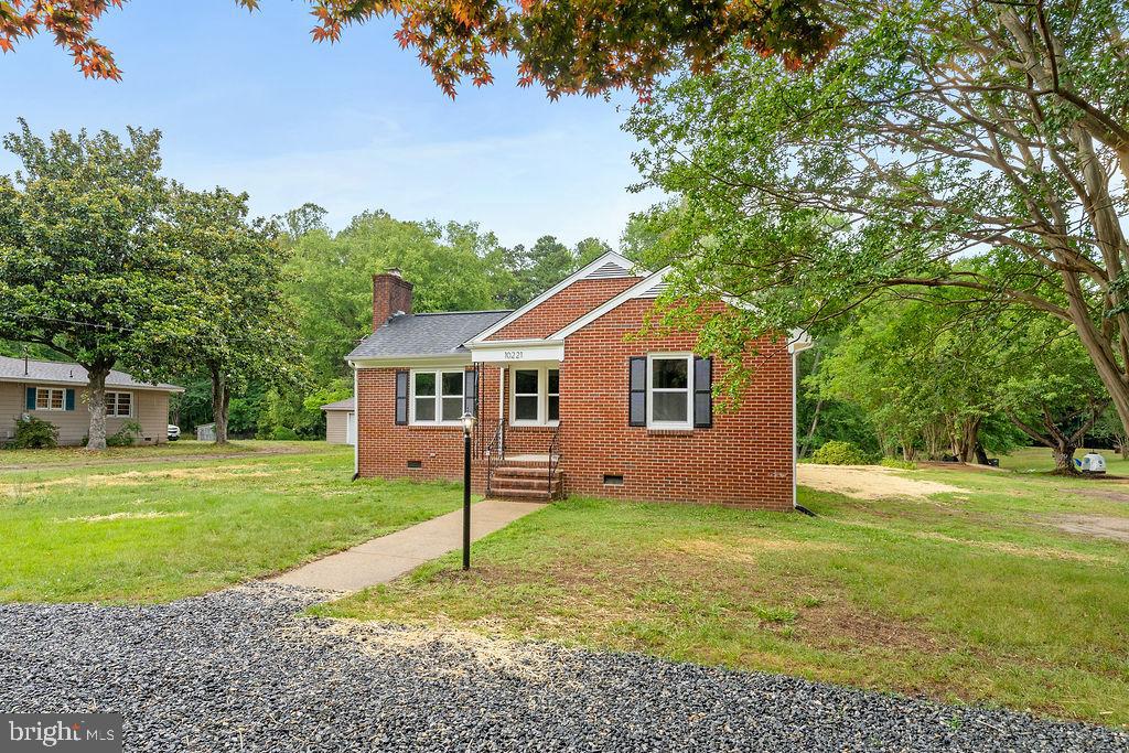 10221 Dahlgren Road King George, VA 22485 - Photo 26 of 31 a front view of a house with a yard and trees