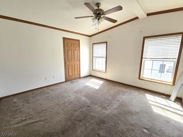 a view of a livingroom with a ceiling fan and window