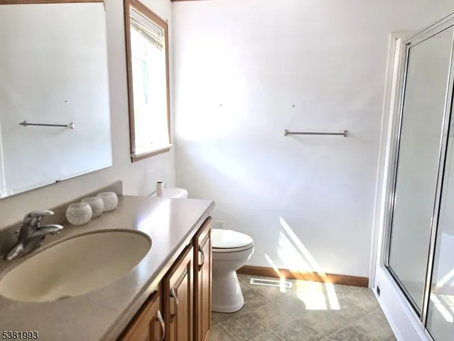 a bathroom with a sink toilet and mirror