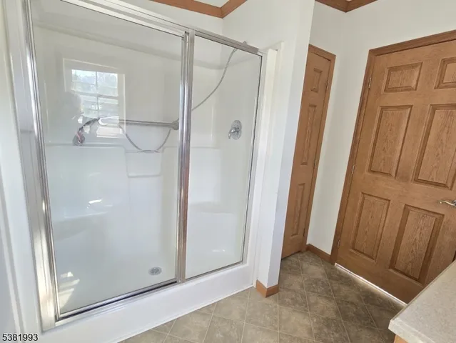 an empty room with wooden floor and mirror