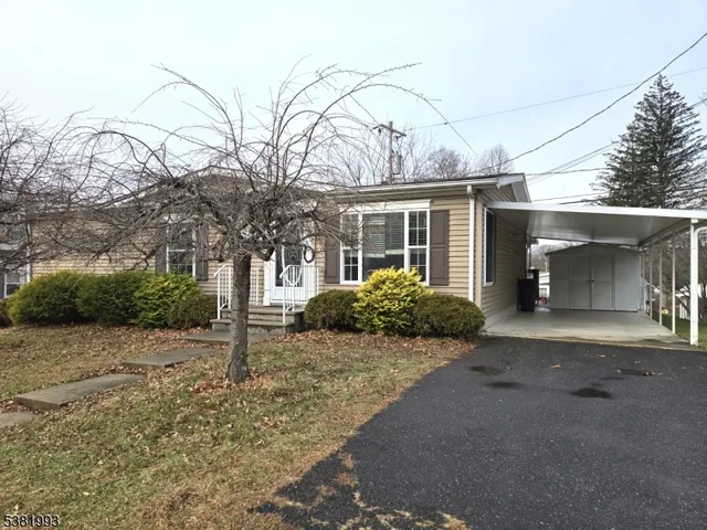 a view of a house with a yard and garage