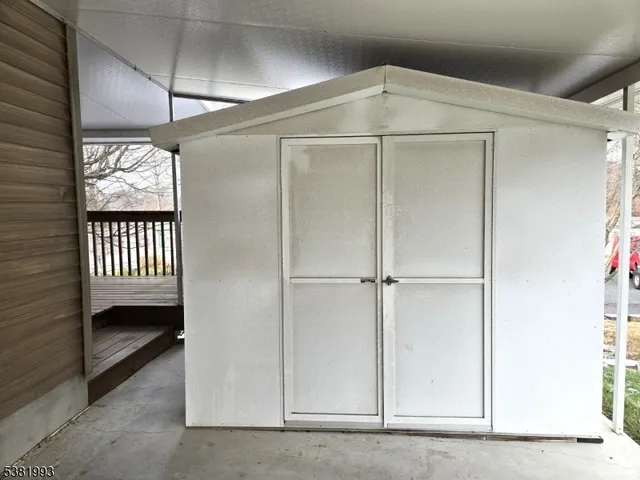 front view of a house with a yard and potted plants