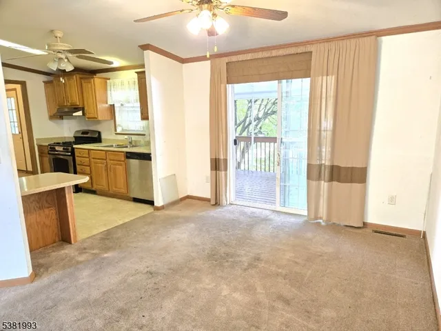 a view of a kitchen with refrigerator and a sink