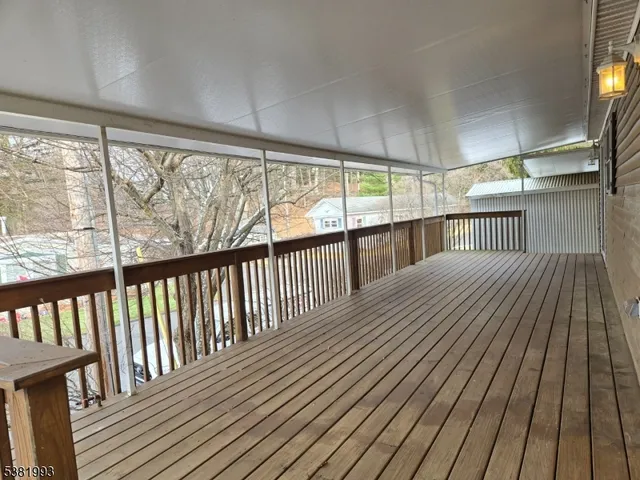 a view of hallway with wooden floor