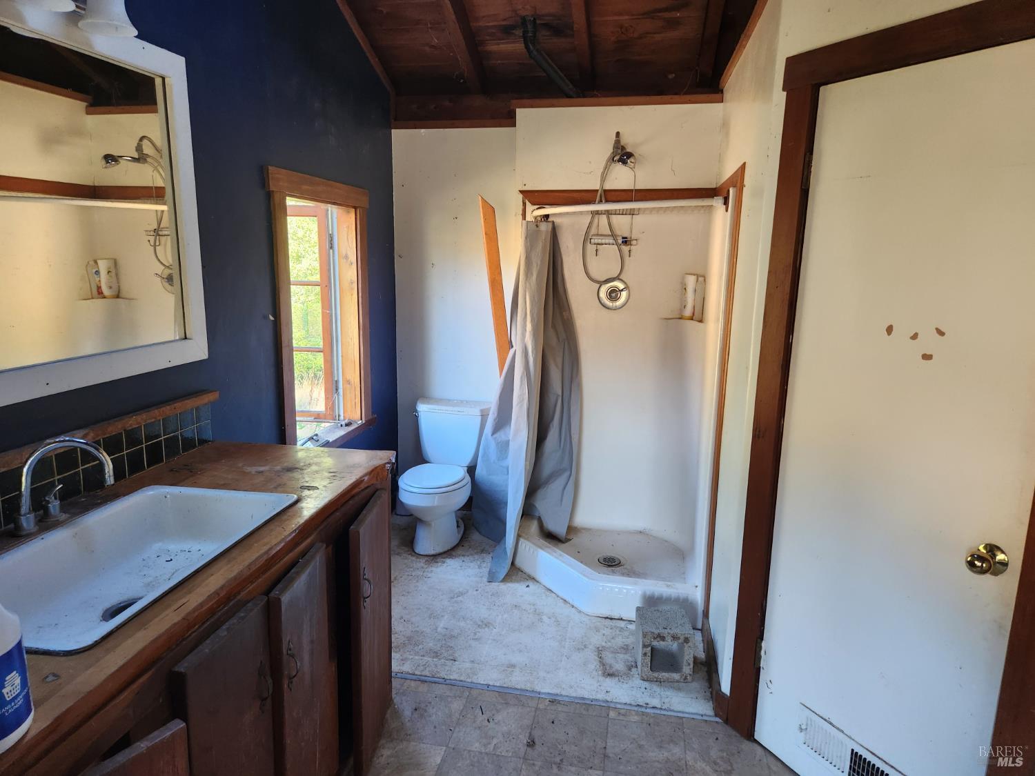 13333 Low Gap Road Ukiah, CA 95482 - Photo 12 of 50 a bathroom with a sink a mirror and a toilet