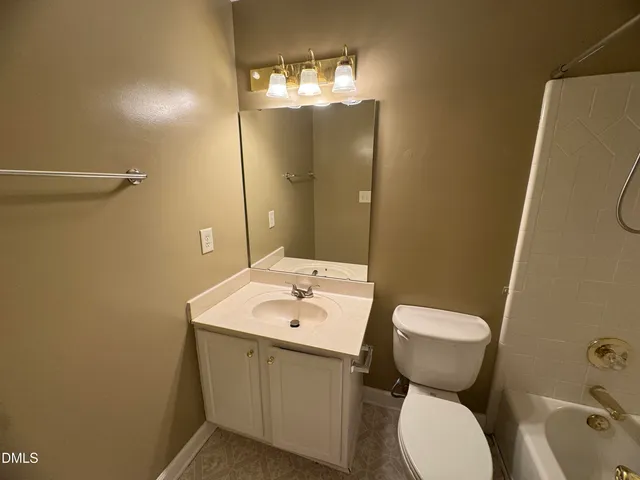 a bathroom with a sink and mirror with toilet