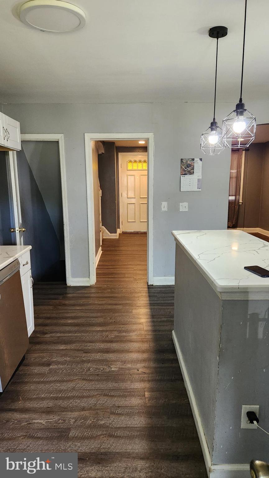 1024 Wicklow Road Baltimore, MD 21229 - Photo 5 of 44 a view of a kitchen with wooden floor and a hallway