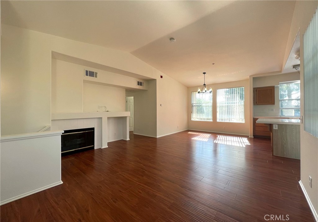 512 Birch Grove Irvine, CA 92618 - Photo 11 of 20 an empty room with wooden floor fireplace and windows