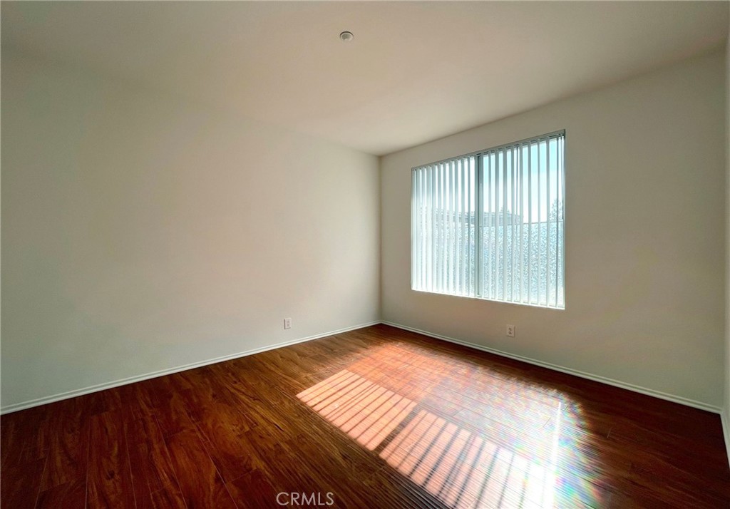 512 Birch Grove Irvine, CA 92618 - Photo 13 of 20 an empty room with wooden floor and windows