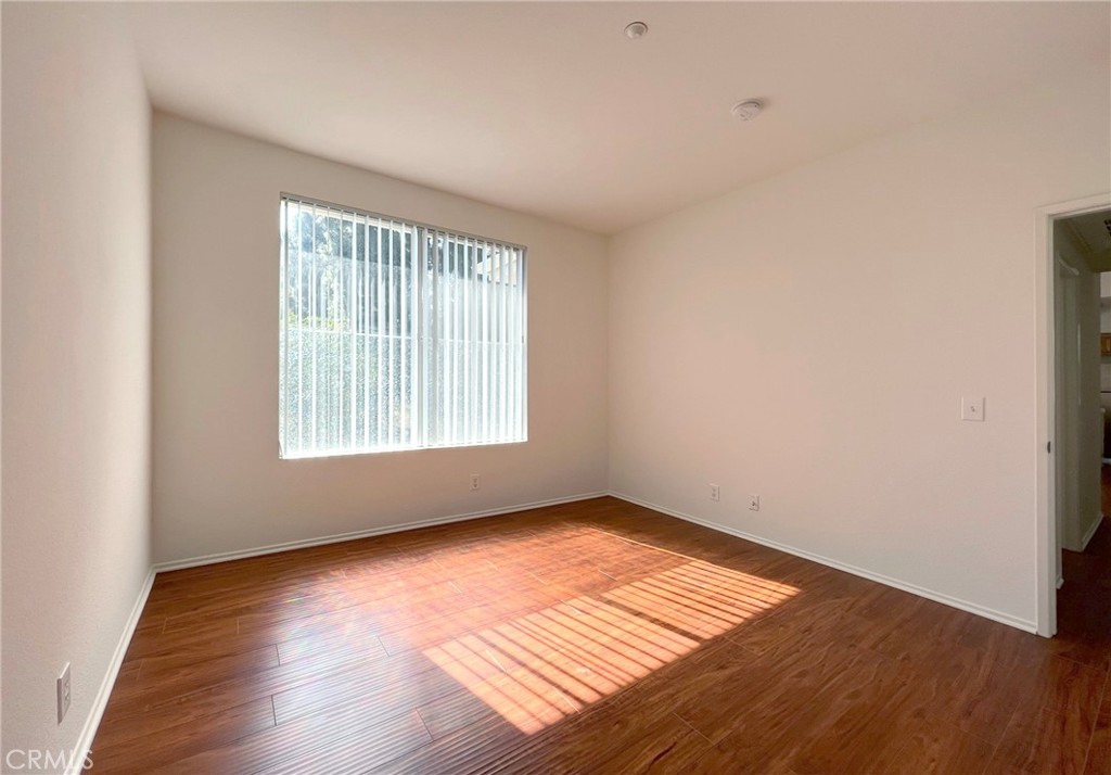 512 Birch Grove Irvine, CA 92618 - Photo 14 of 20 an empty room with wooden floor and windows
