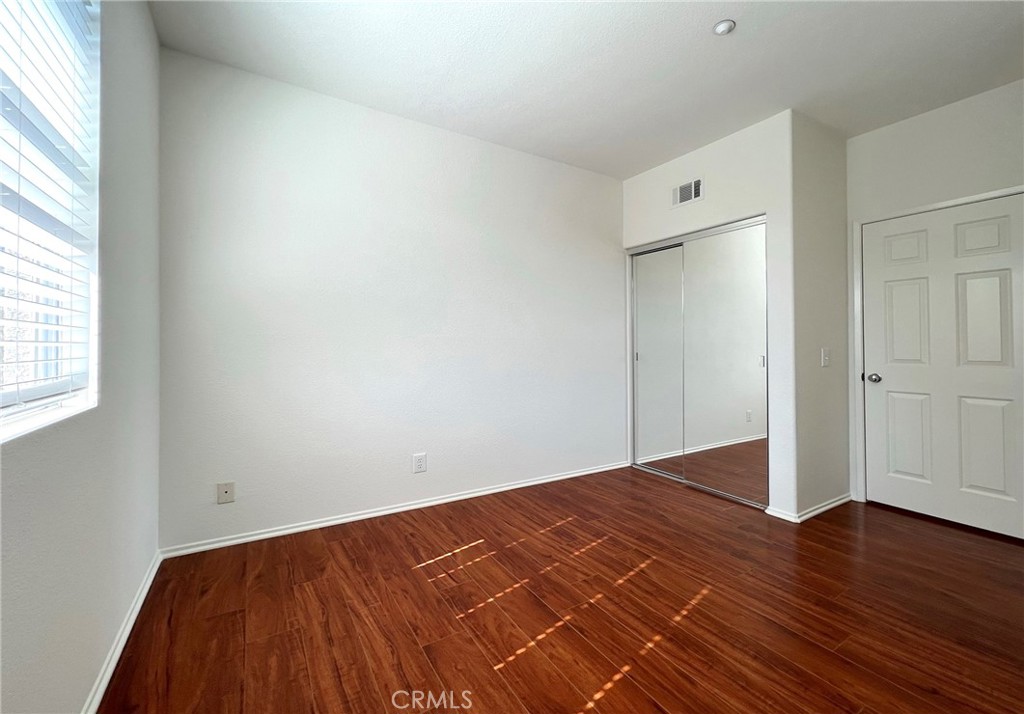 512 Birch Grove Irvine, CA 92618 - Photo 15 of 20 an empty room with wooden floor and windows