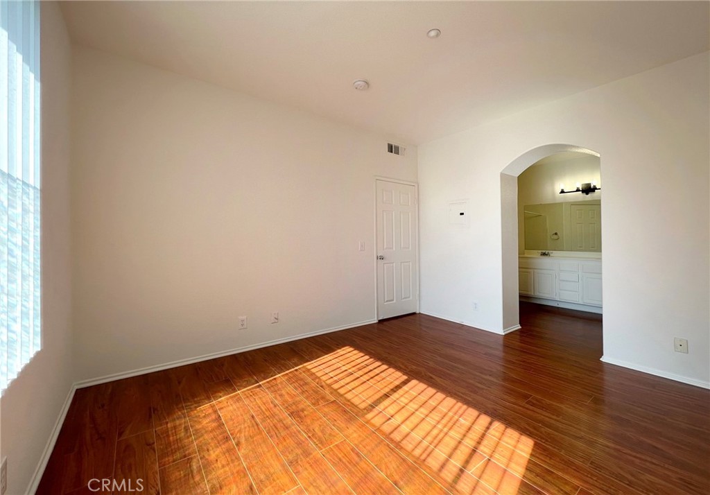 512 Birch Grove Irvine, CA 92618 - Photo 16 of 20 a view of empty room with wooden floor and fan