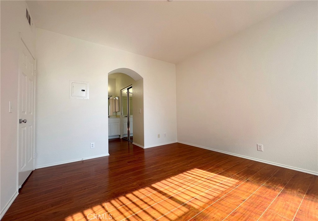 512 Birch Grove Irvine, CA 92618 - Photo 17 of 20 a view of an empty room with wooden floor and a window