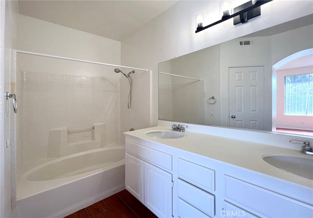 512 Birch Grove Irvine, CA 92618 - Photo 18 of 20 a bathroom with a sink double vanity granite tub shower and a mirror