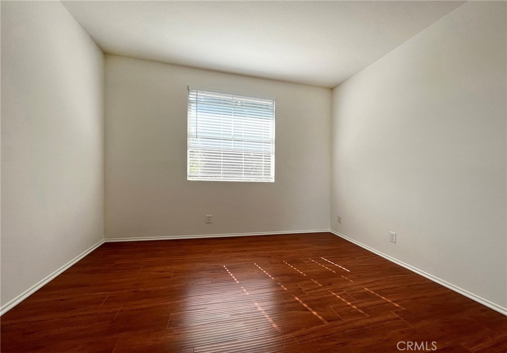 512 Birch Grove Irvine, CA 92618 - Photo 19 of 20 an empty room with wooden floor and windows