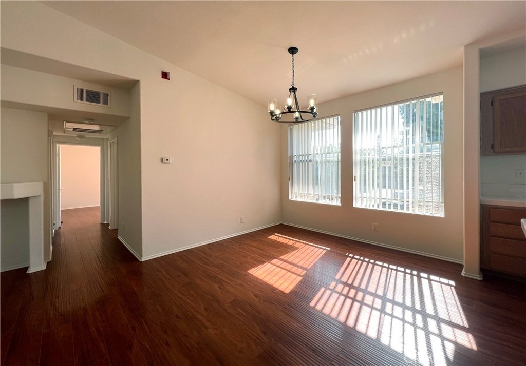 512 Birch Grove Irvine, CA 92618 - Photo 4 of 20 a view of an empty room with window and wooden floor