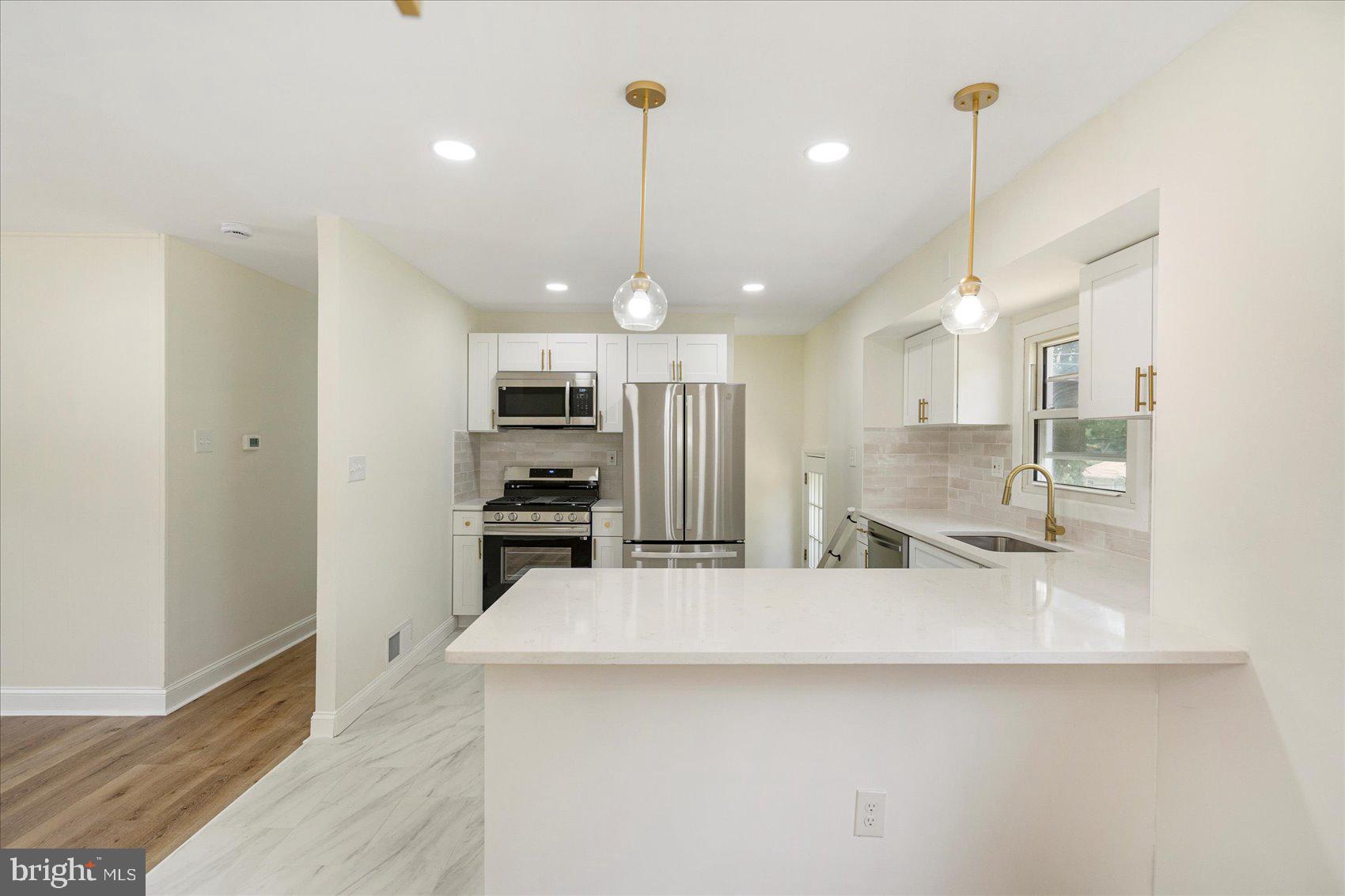 6726 Longhill Road Baltimore, MD 21207 - Photo 14 of 36 a kitchen with kitchen island a counter top space appliances and cabinets