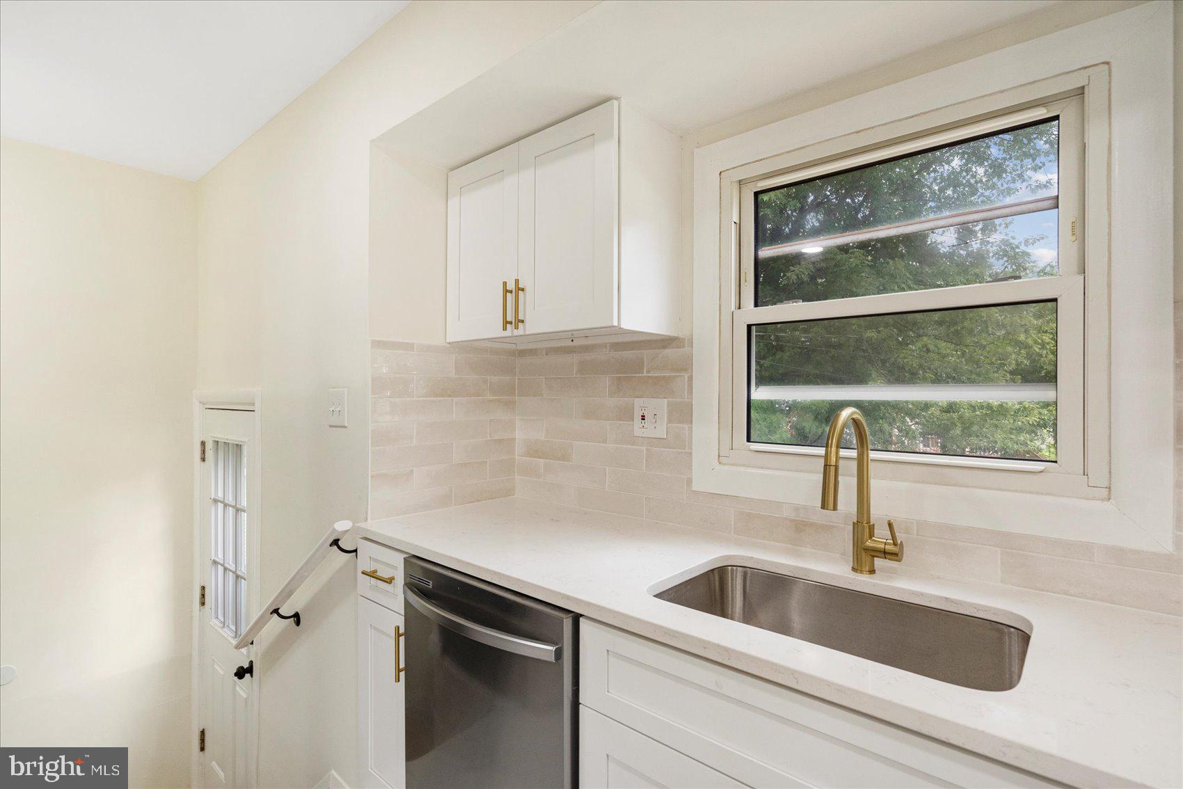 6726 Longhill Road Baltimore, MD 21207 - Photo 19 of 36 a kitchen with a sink and large window