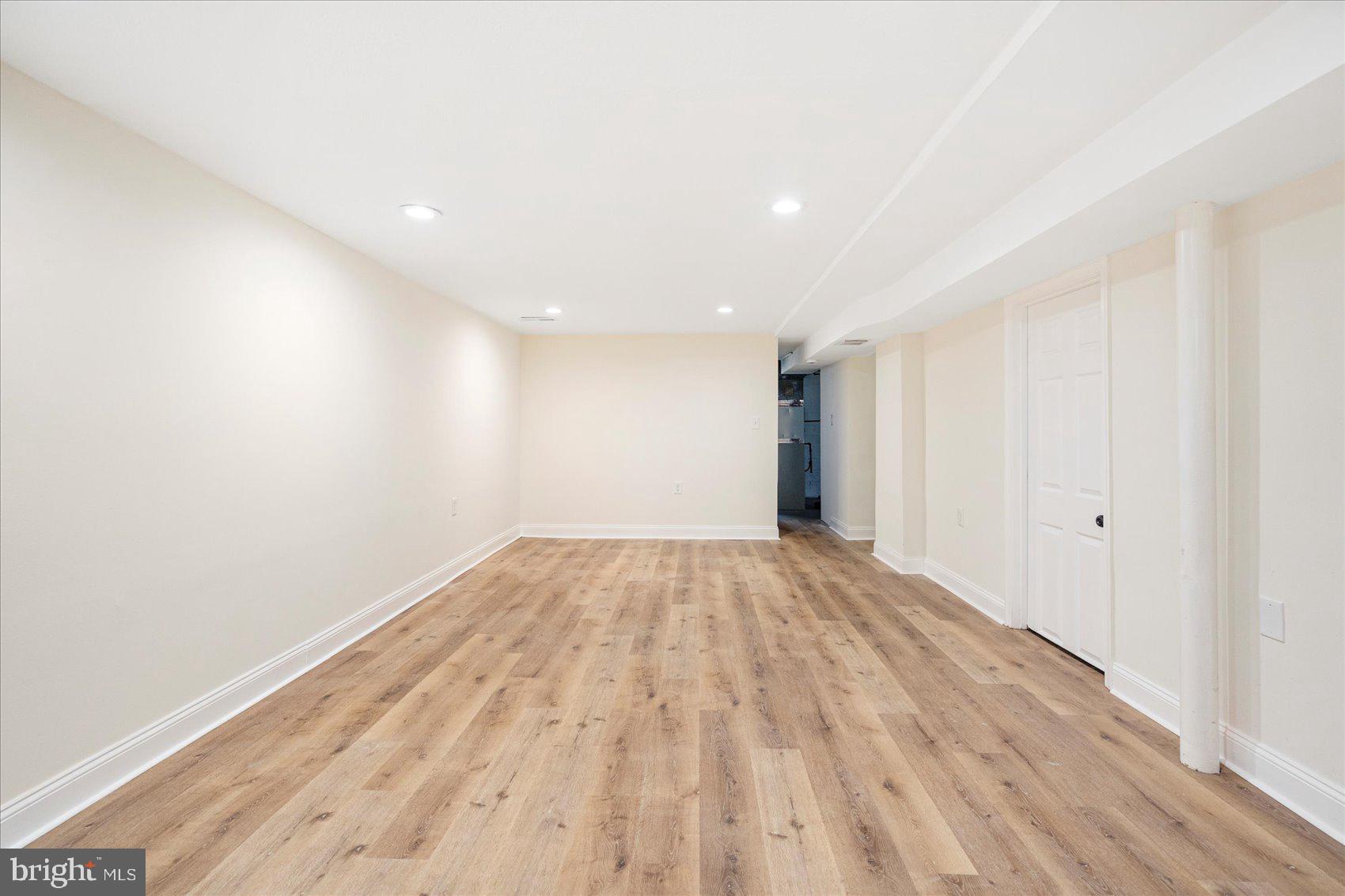 6726 Longhill Road Baltimore, MD 21207 - Photo 21 of 36 a view of empty room with wooden floor