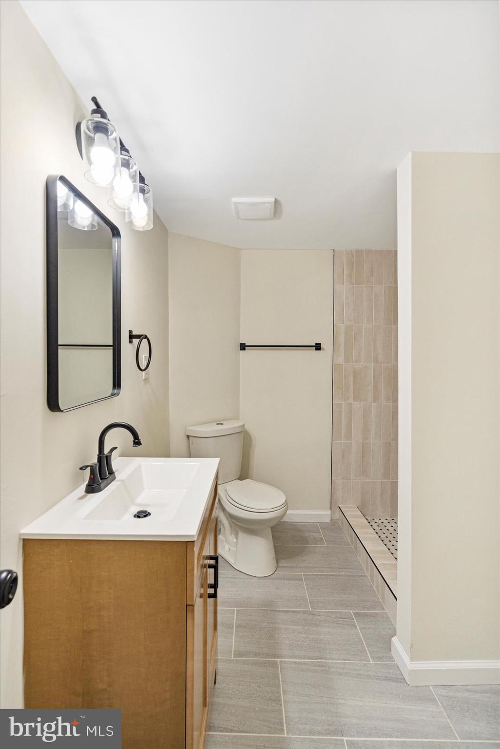 6726 Longhill Road Baltimore, MD 21207 - Photo 24 of 36 a bathroom with a sink toilet and mirror