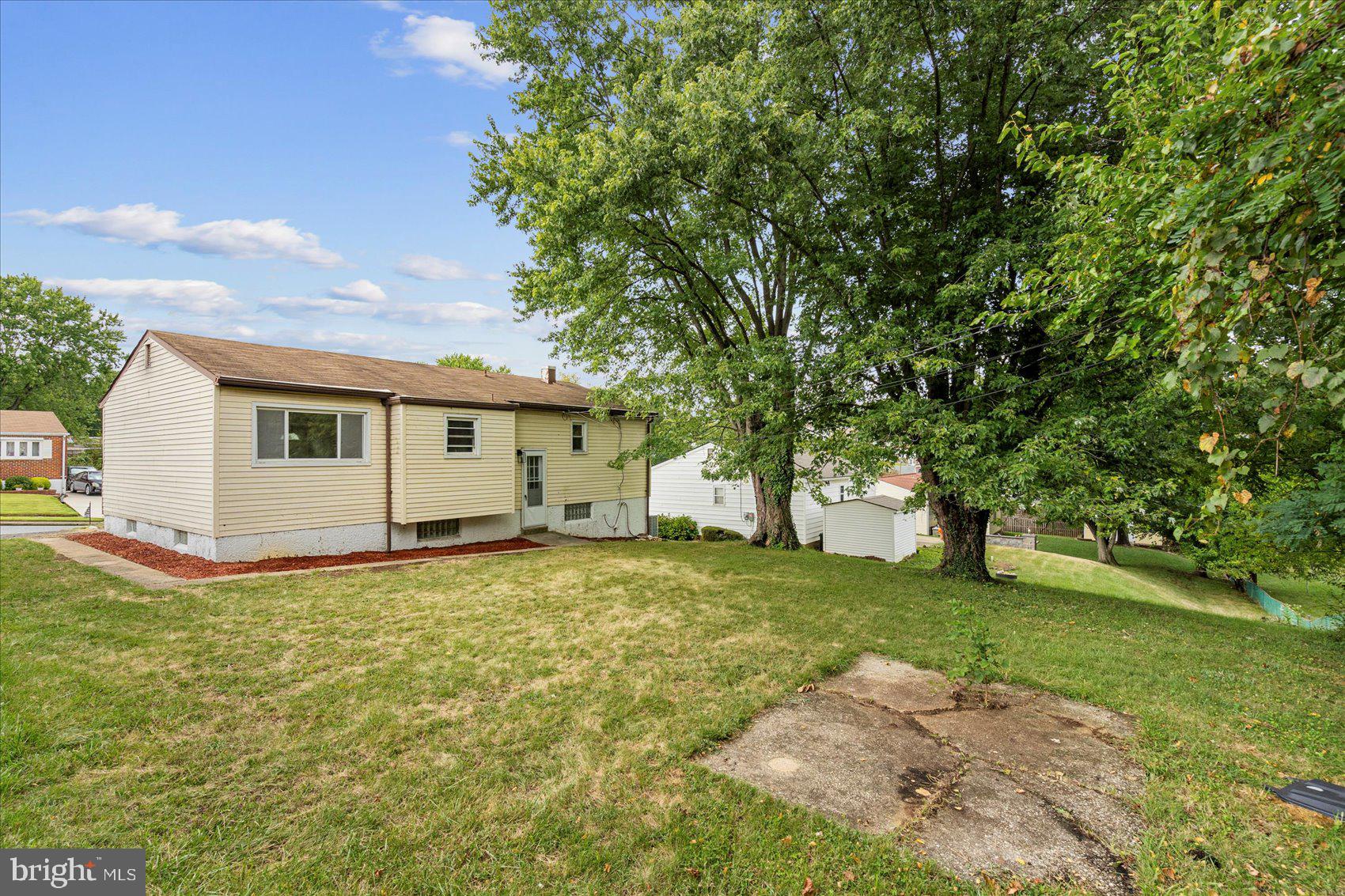 6726 Longhill Road Baltimore, MD 21207 - Photo 4 of 36 a view of a house with a backyard