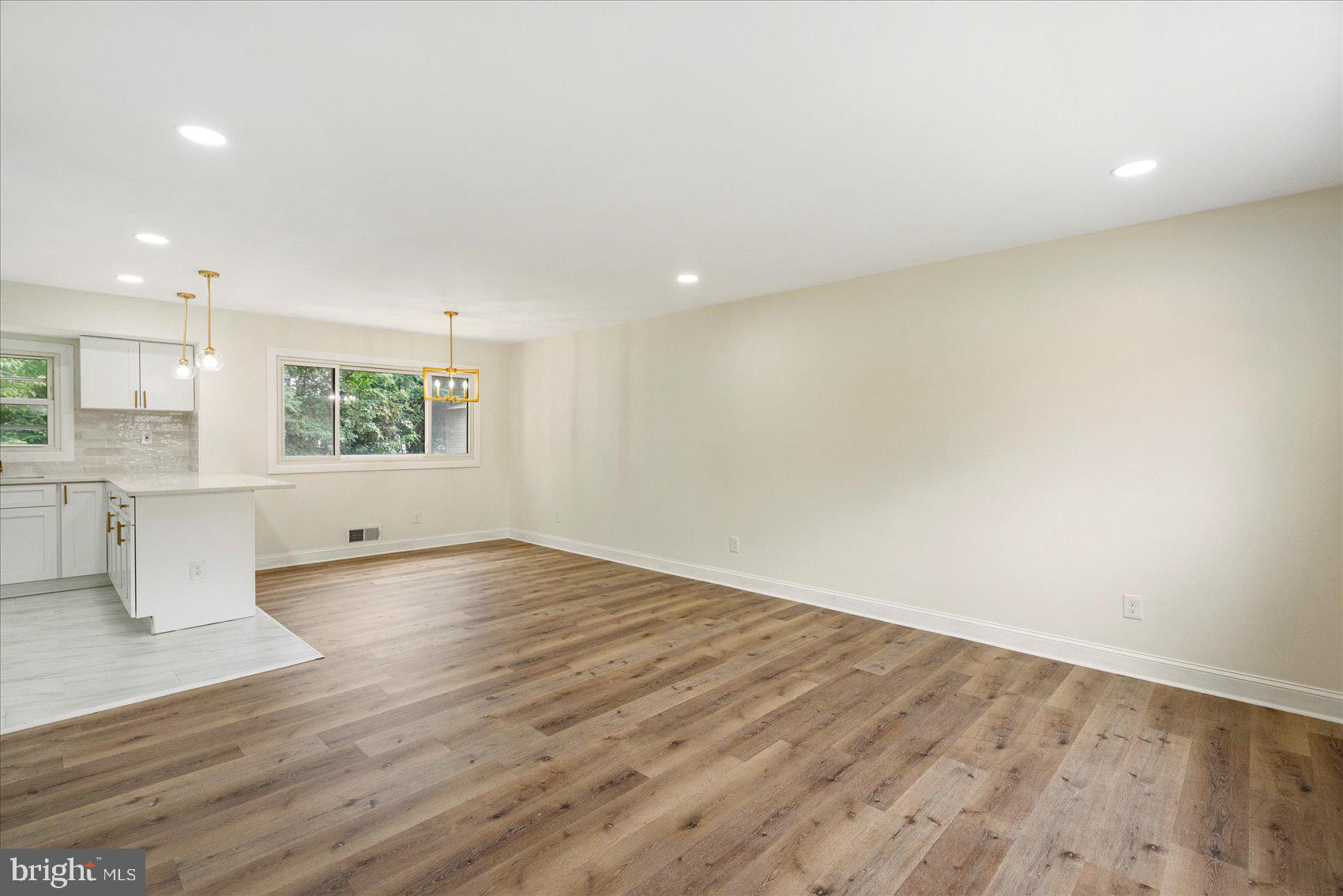 6726 Longhill Road Baltimore, MD 21207 - Photo 6 of 36 wooden floor in an empty room with a window