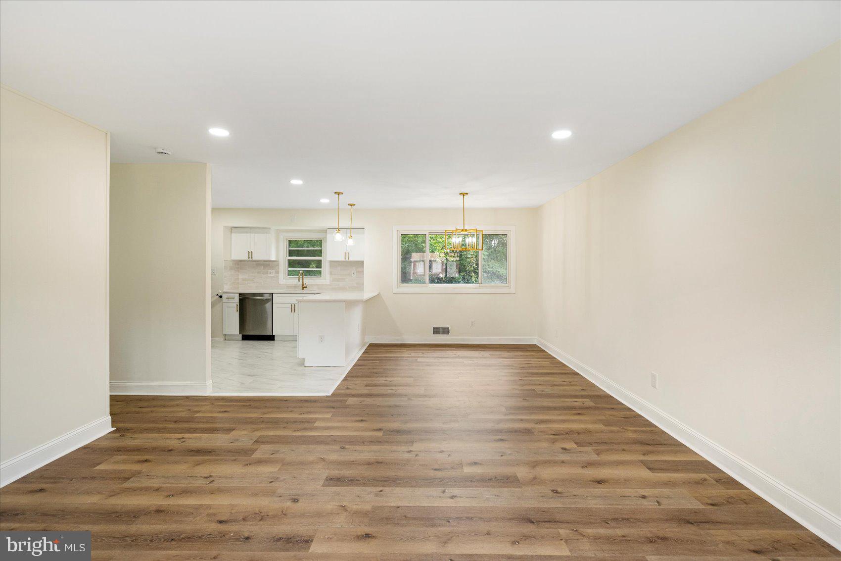 6726 Longhill Road Baltimore, MD 21207 - Photo 7 of 36 a view of empty room with wooden floor and windows