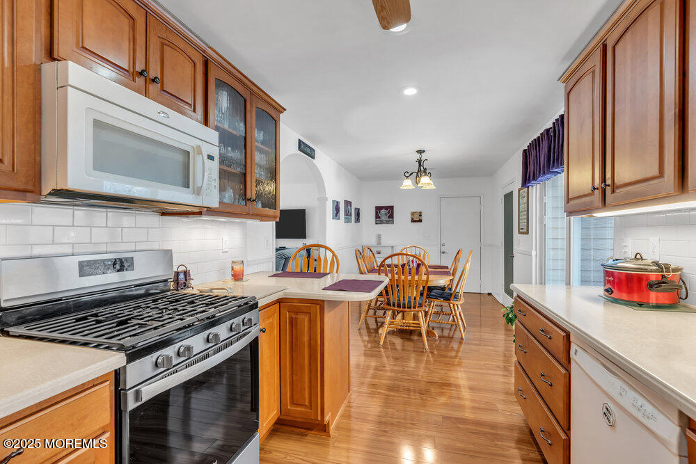 64 Sunset Drive Howell, NJ 07731 - Photo 11 of 24 a kitchen with stainless steel appliances granite countertop a stove and a sink
