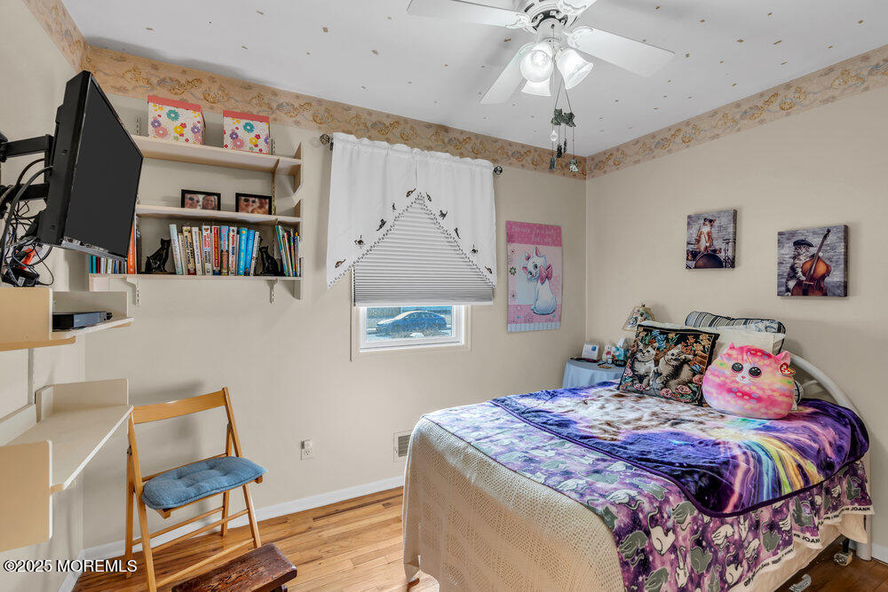 64 Sunset Drive Howell, NJ 07731 - Photo 13 of 24 a bedroom with a bed and a chandelier