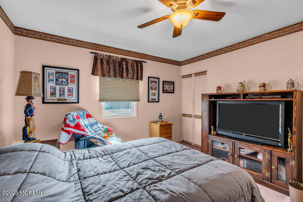 64 Sunset Drive Howell, NJ 07731 - Photo 14 of 24 a bedroom with a bed and a flat screen tv