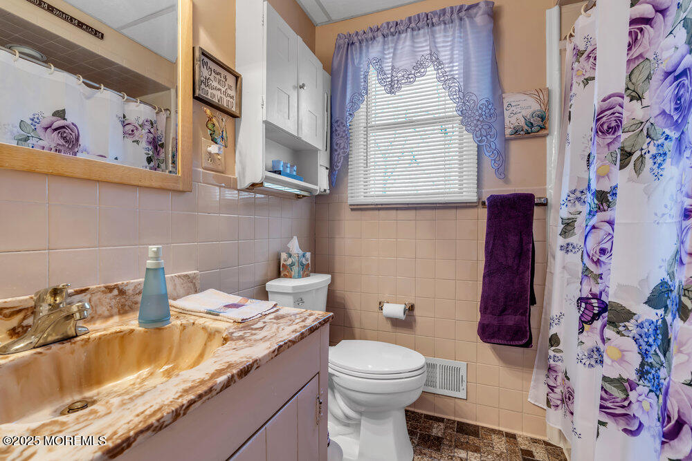 64 Sunset Drive Howell, NJ 07731 - Photo 16 of 24 a bathroom with a sink and a toilet