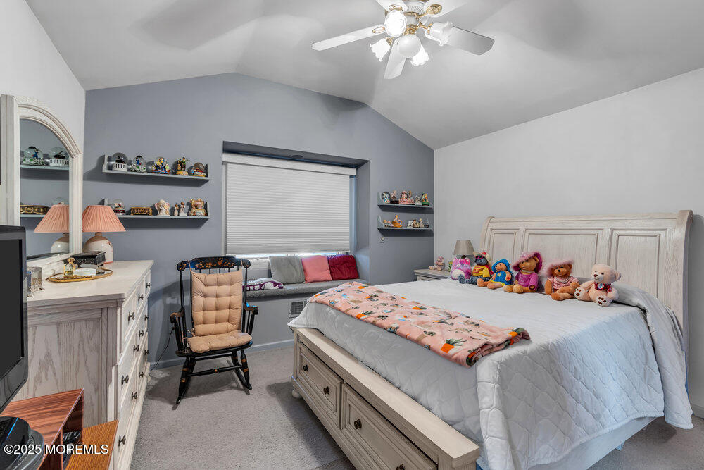 64 Sunset Drive Howell, NJ 07731 - Photo 17 of 24 a bedroom with a bed and a chandelier