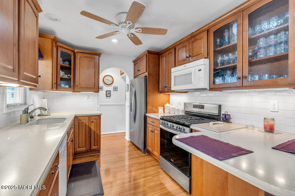64 Sunset Drive Howell, NJ 07731 - Photo 10 of 24 a kitchen with stainless steel appliances granite countertop a sink stove and refrigerator