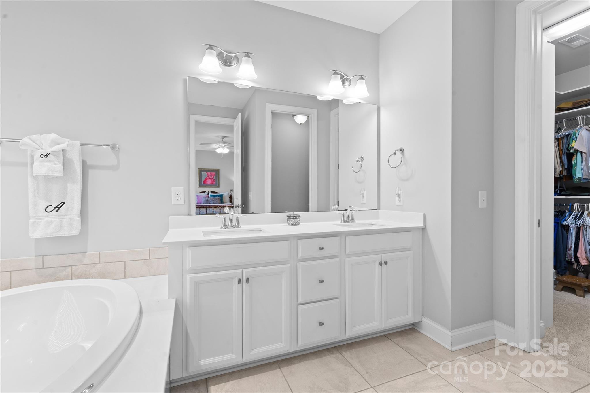 950 Emory Lane Fort Mill, SC 29708 - Photo 20 of 40 a bathroom with a granite countertop sink a large mirror and a bathtub