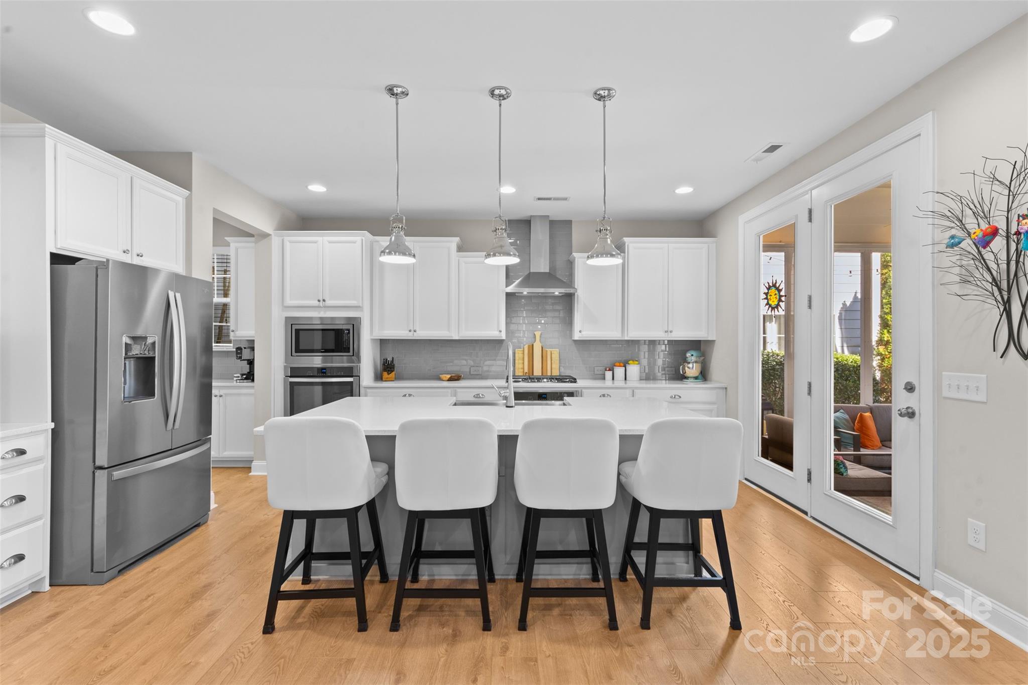 950 Emory Lane Fort Mill, SC 29708 - Photo 3 of 40 a kitchen with stainless steel appliances a dining table chairs refrigerator and microwave