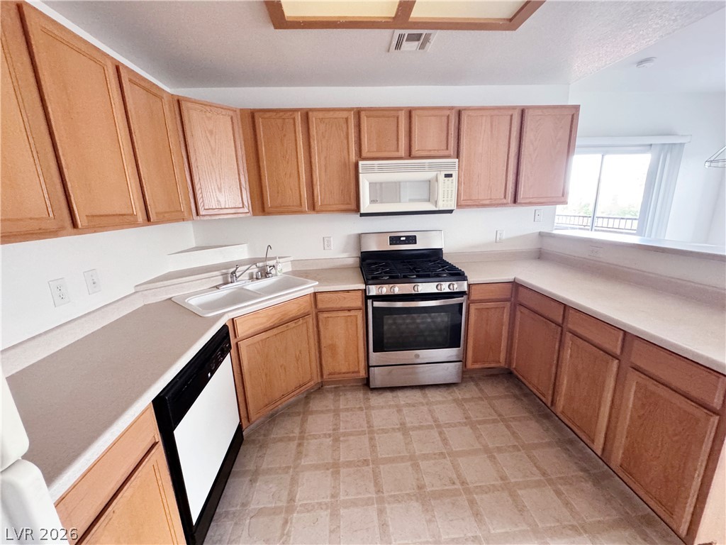 9580 West Reno Avenue, Unit 242 Las Vegas, NV 89148 - Photo 8 of 26 A well-appointed kitchen features ample cabinetry, a full suite of appliances, and a convenient breakfast bar.
