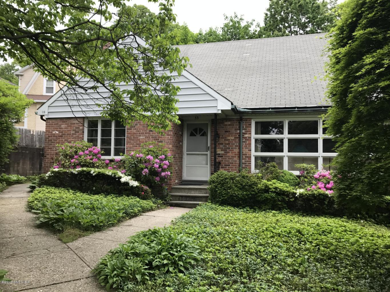 35 Sound View Drive Greenwich, CT 06830 - Photo 1 of 11 a front view of a house with garden