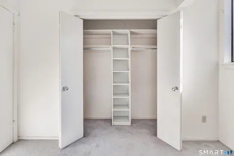 a view of a kitchen with white cabinets