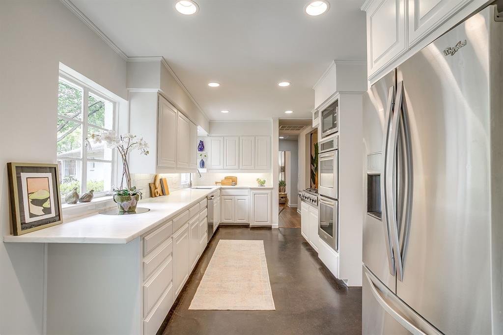 624 Edgefield Road Fort Worth, TX 76107 - Photo 18 of 37 a kitchen with white cabinets and white stainless steel appliances