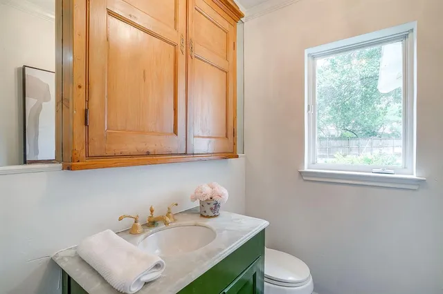 a bathroom with a sink a toilet and a mirror
