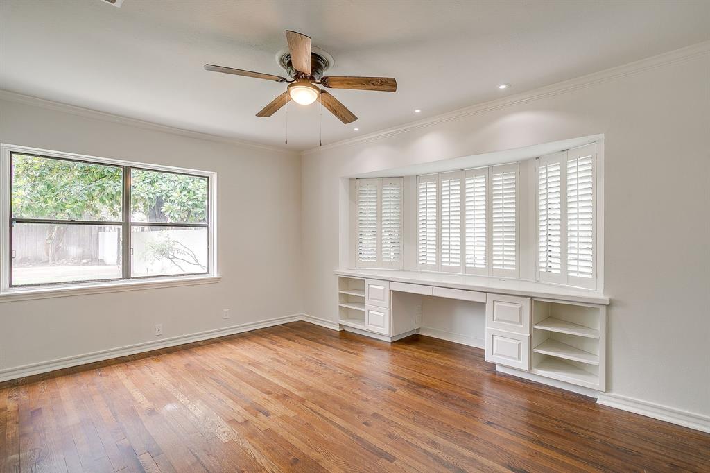 624 Edgefield Road Fort Worth, TX 76107 - Photo 21 of 37 a view of an empty room with wooden floor and a window
