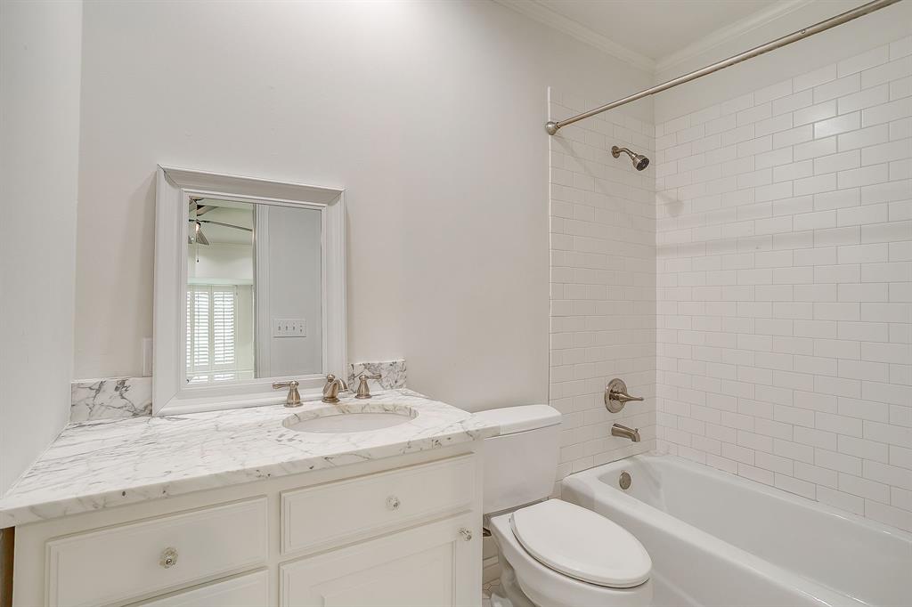 624 Edgefield Road Fort Worth, TX 76107 - Photo 23 of 37 a bathroom with a granite countertop sink toilet and shower