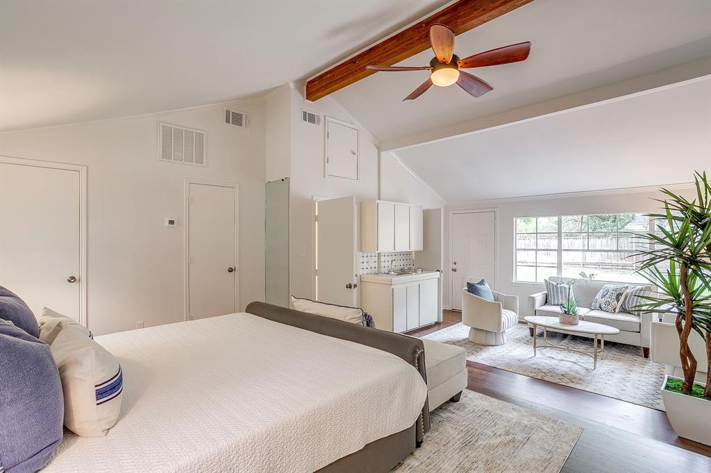 624 Edgefield Road Fort Worth, TX 76107 - Photo 30 of 37 a spacious bedroom with a bed a chandelier and a couch